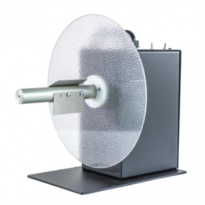 Prietaiso nuotrauka, kurioje matosi pusiau permatomas diskas ant metalinės plokštės su metaliniu cilindru priekyje, viskas prieš baltą foną.